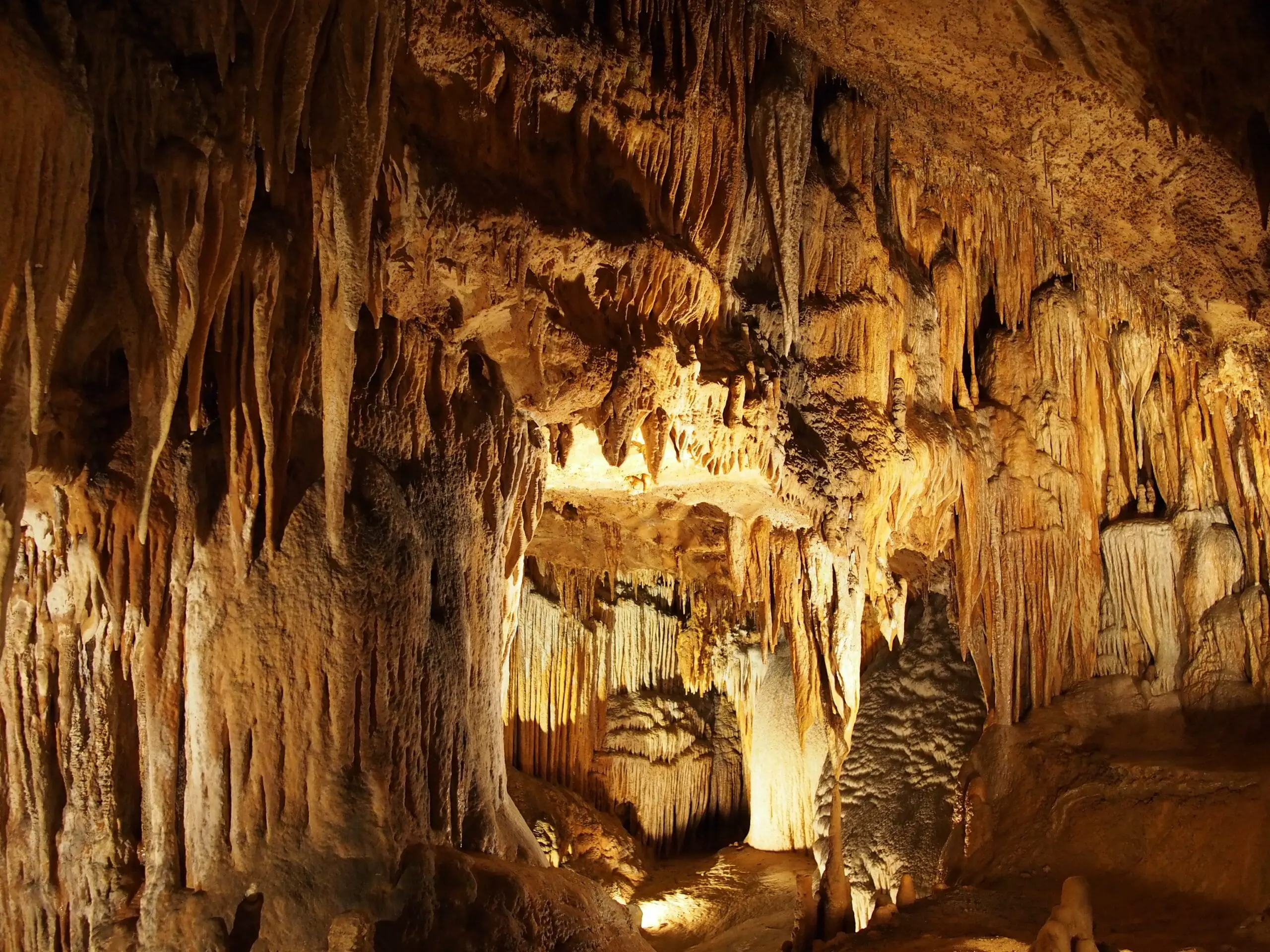 Stalactites and stalagmites inside a natural limestone cavern