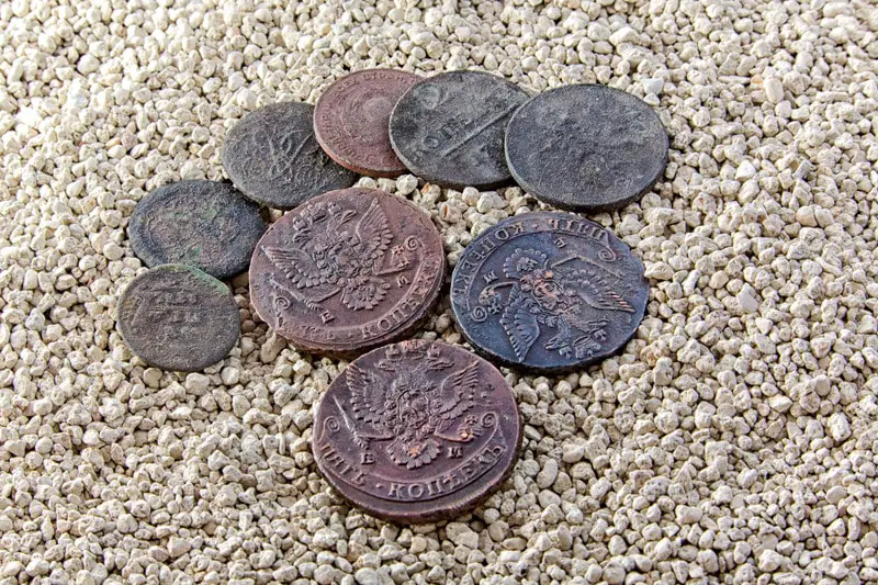 Old copper coins in the sand.