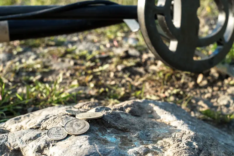 metal detector and old coins of the USSR times on the stone, the results of the coin search