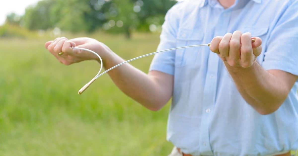 Man holding a dowsing rod.