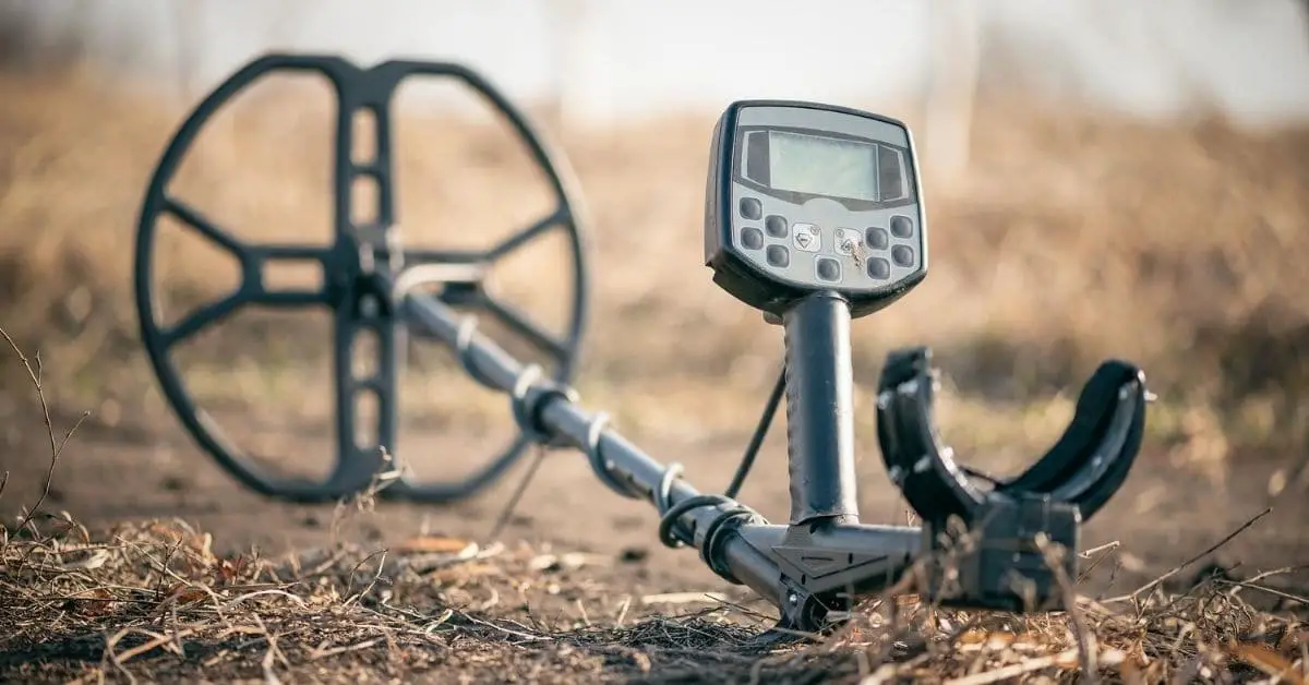 Metal detector laying on the ground.