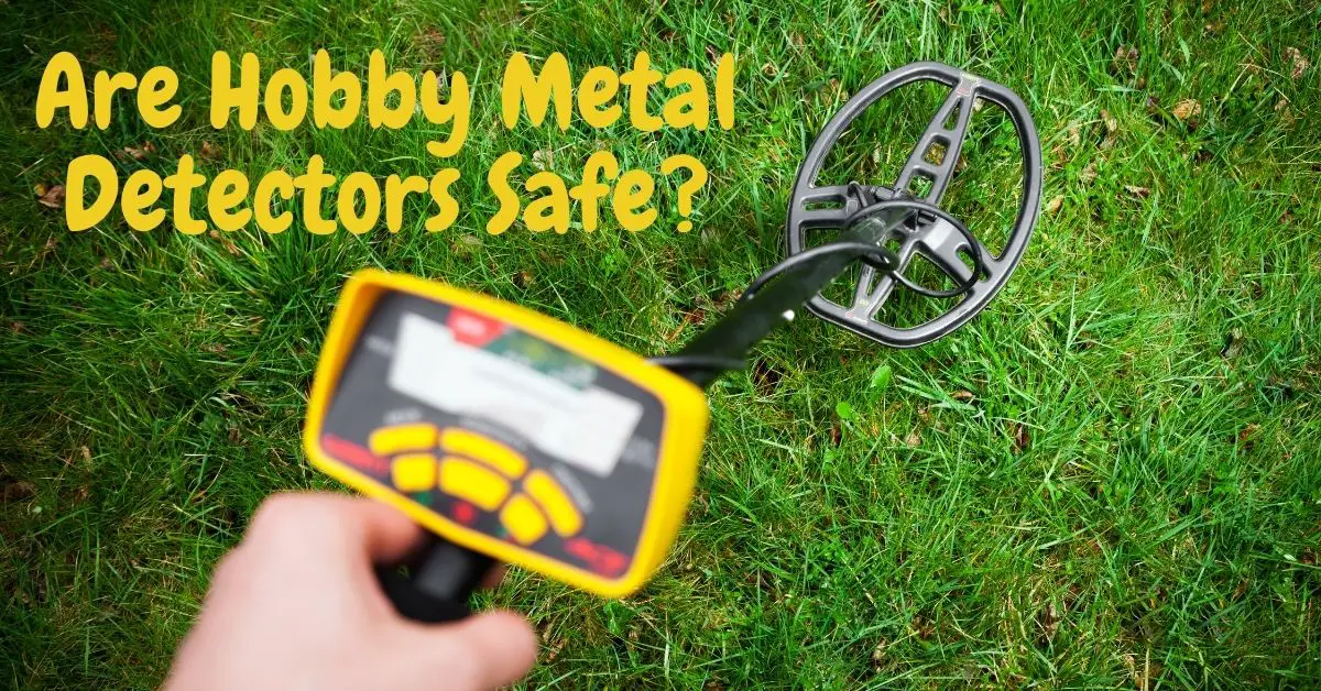 Metal detector in the grass and the words are hobby metal detectors safe?