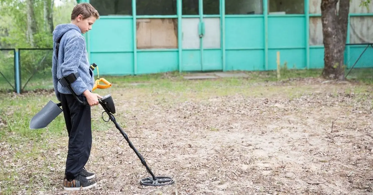 Young boy metal detecting