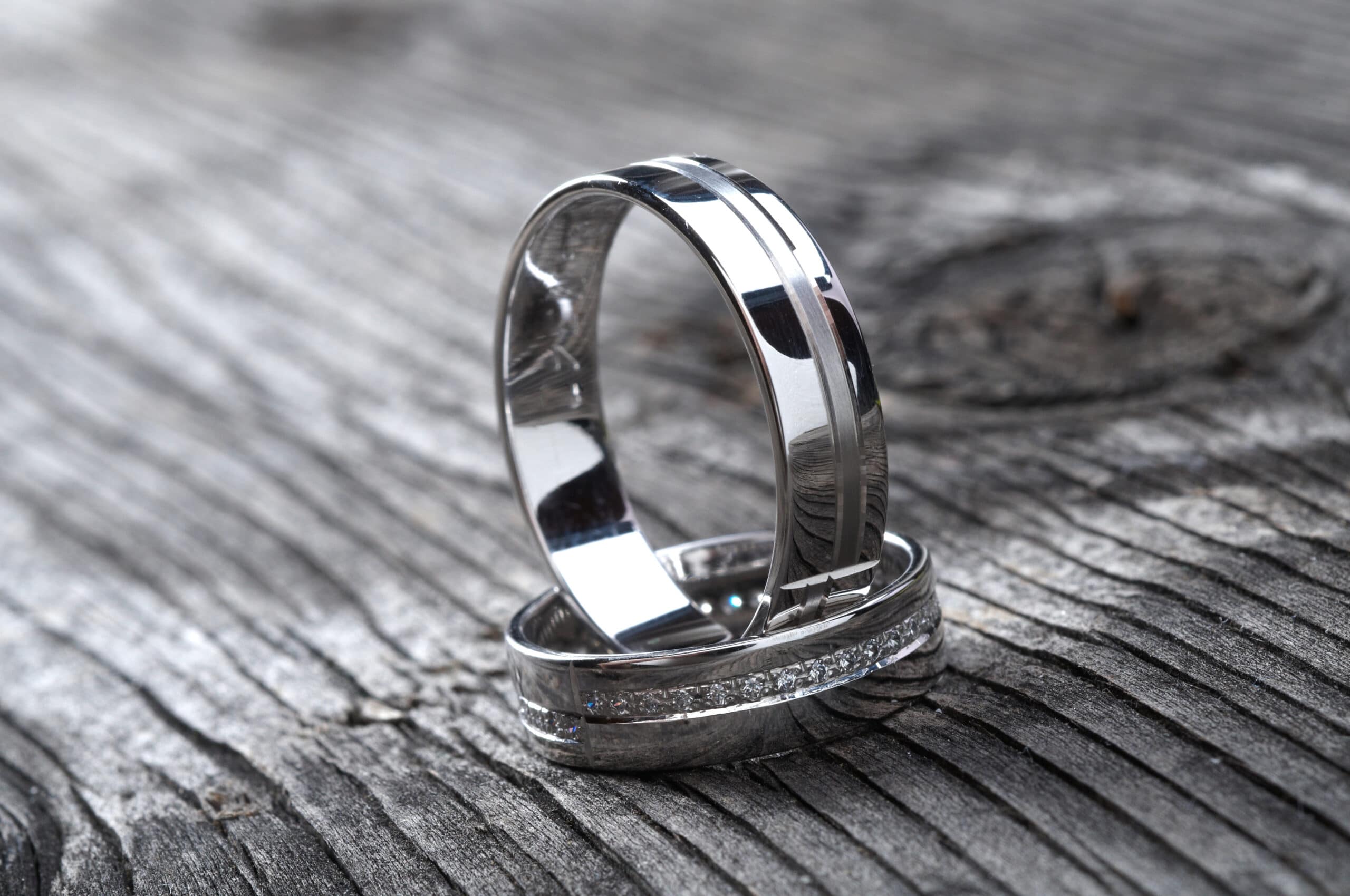 Two wedding rings on rustic wood, b&w