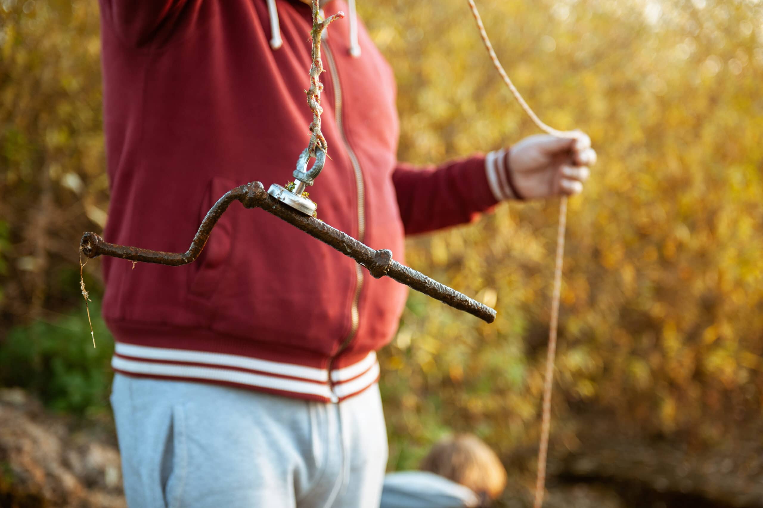 Image of a man magnet fishing.