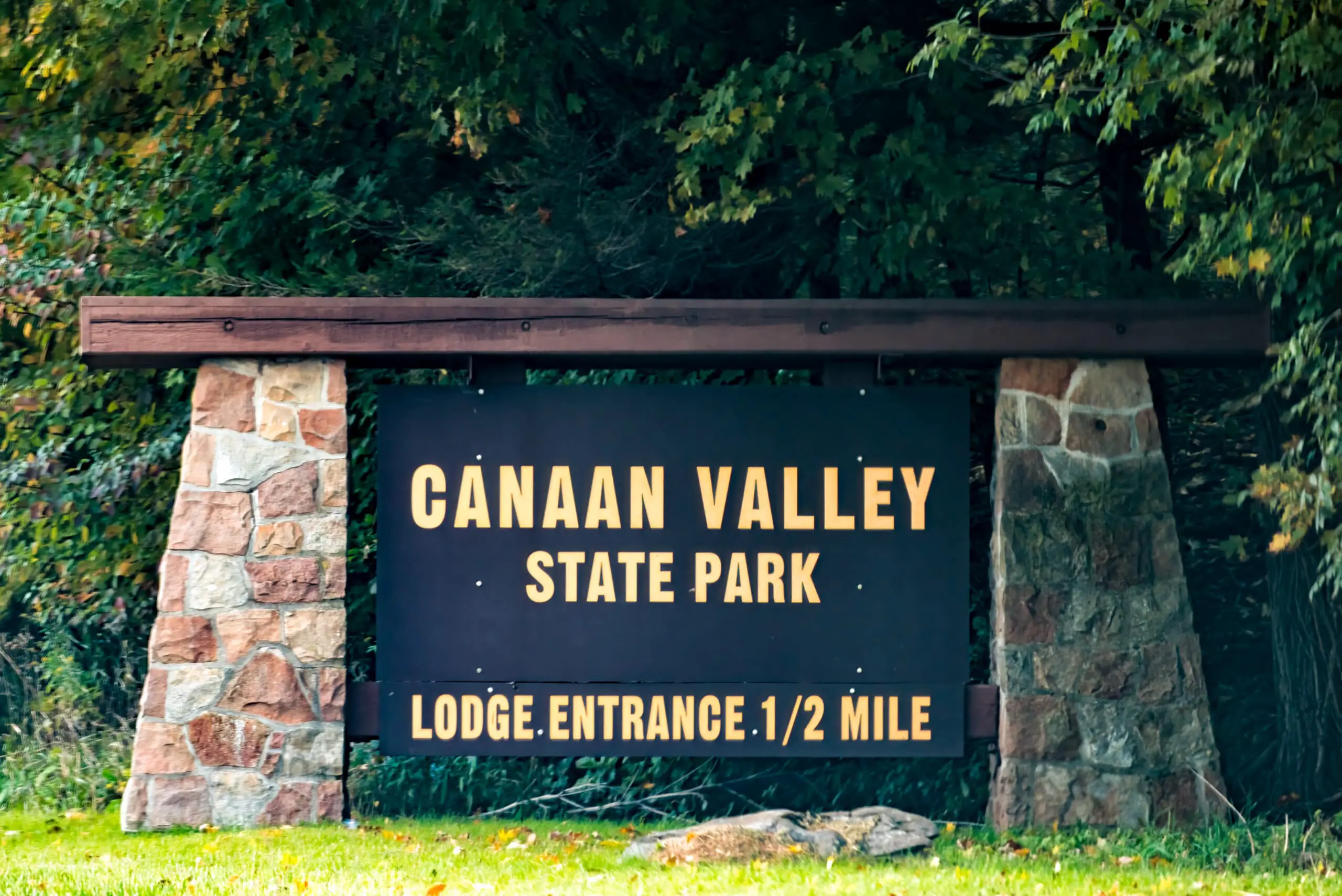 Sign on road for Canaan valley ski resort and conference center in state park in Davis, West Virginia at colorful autumn fall season