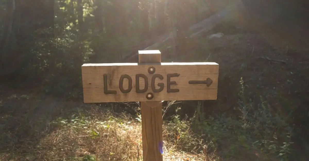 Sign with the word lodge on it and an arrow pointing the way