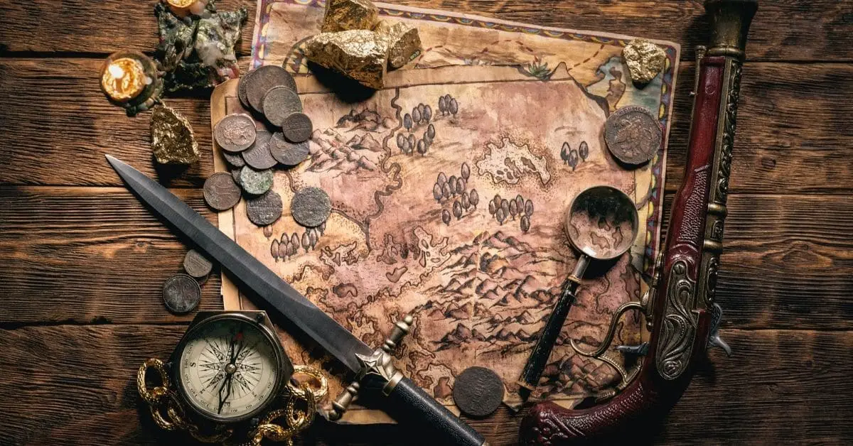 Coins, Knife and an old gun on a treasure map
